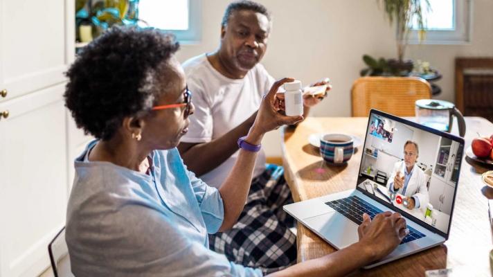 Couple having a telemedicine visit with their doctor