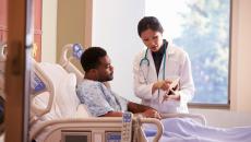 Doctor showing patient a tablet screen.