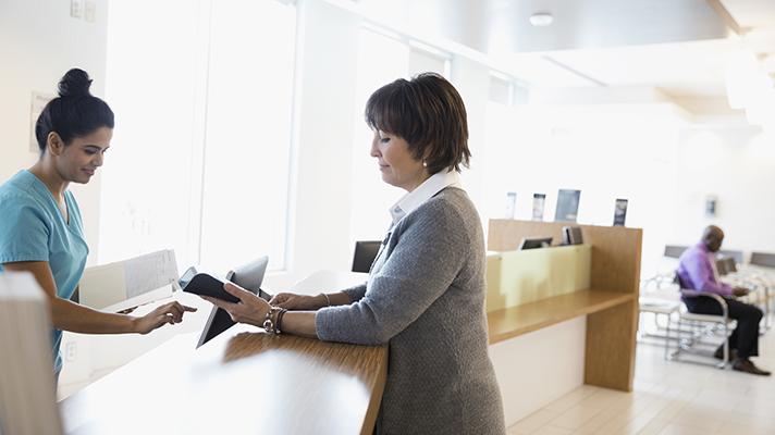 female patient paying bill next-gen revenue cycle