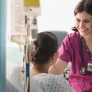 Healthcare worker talking to patient in hospital