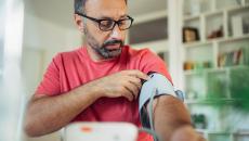 Person using blood pressure cuff