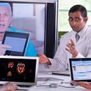 Doctors meeting with laptops and other doctor on a screen