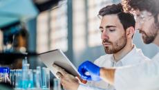 Laboratory workers using tablet