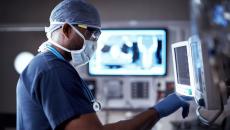 Surgeon standing in front of a monitor