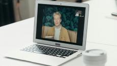 Laptop on a table showing the parties in a video meeting