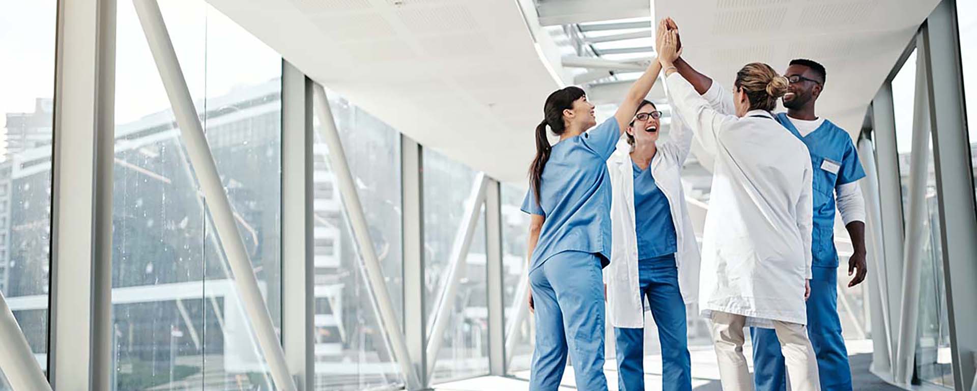 Group of healthcare workers sharing a high-five