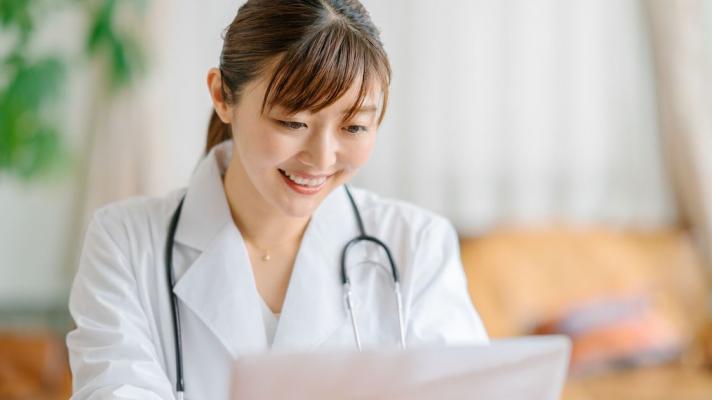 A doctor teleconsulting using a laptop computer