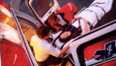 A patient on a stretcher being boarded into an ambulance vehicle.