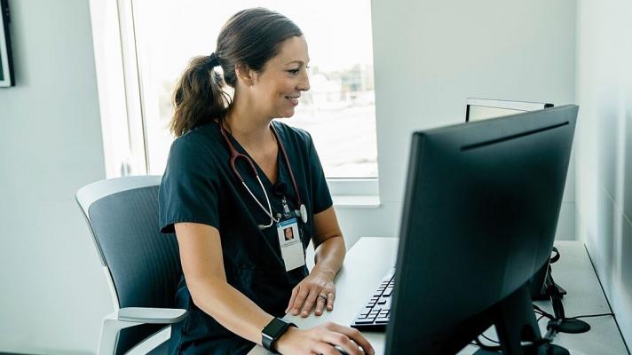 A doctor using a desktop computer